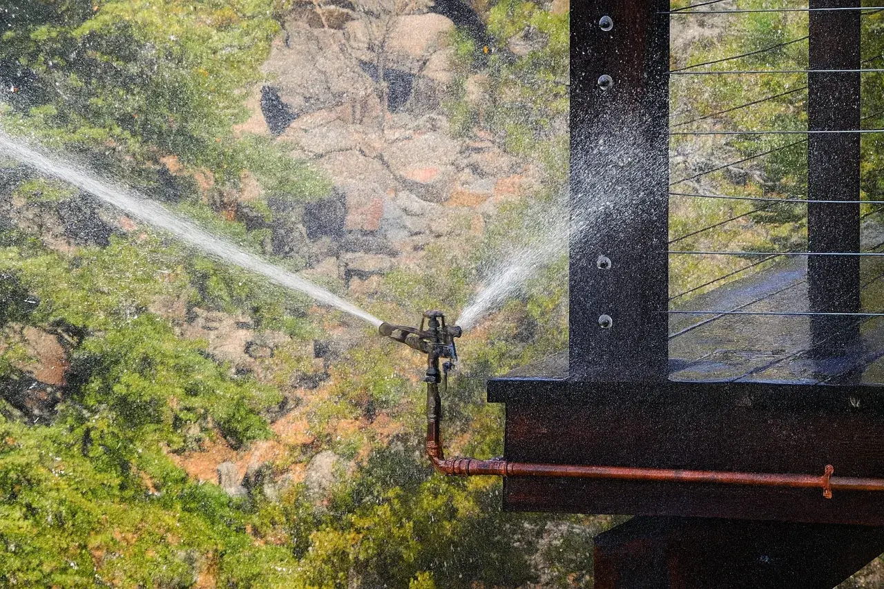 Roof-mounted wildfire defense sprinklers